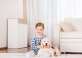 Smiling little girl sitting with retriever puppy Royalty Free Stock Photo