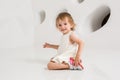 Smiling little girl sitting on the floor on a white background Royalty Free Stock Photo