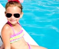 Smiling little girl sitting near swimming pool Royalty Free Stock Photo