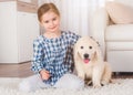 Smiling little girl sitting with retriever puppy Royalty Free Stock Photo