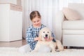 Smiling little girl sitting with retriever puppy Royalty Free Stock Photo