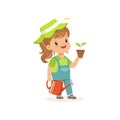 Smiling little girl standing with plant and watering can in hands. Flat kid character dressed as gardener Dream