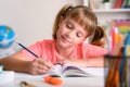 Smiling little girl studying in her room at home Royalty Free Stock Photo