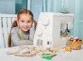 Smiling little girl at the table with sewing Royalty Free Stock Photo