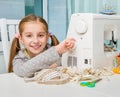 Smiling little girl at the table with sewing Royalty Free Stock Photo