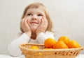 Smiling little girl with tangerines