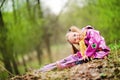 Smiling little girl with umbrella in the park