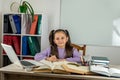 smiling little girl is watching a video lesson on the computer. Royalty Free Stock Photo