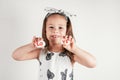 Smiling little girl in white clothes hold white smooth stones with syllables lo and ve painted red on white background. Royalty Free Stock Photo