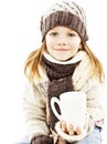 Smiling little girl with a white cup of hot drink. Royalty Free Stock Photo