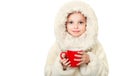 Smiling little girl in winter clothes with a red cup of hot drink Royalty Free Stock Photo