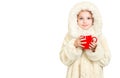 Smiling little girl in winter clothes with a red cup of hot drink Royalty Free Stock Photo