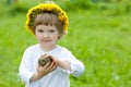 Smiling little girl in yellow chaplet Royalty Free Stock Photo