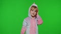 Little kid girl daughter in unicorn pajamas using speaking talking on mobile cell phone with mother Royalty Free Stock Photo