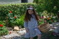 Smiling little latina girl in garden in Spring dress with Basket