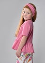 Smiling little red-haired girl child turning from back looking at camera Royalty Free Stock Photo