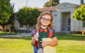 Smiling little school student wit backpack book. Portrait of happy young boy outside the primary school. Closeup face of Royalty Free Stock Photo