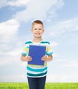 Smiling little student boy with blue book Royalty Free Stock Photo