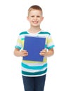 Smiling little student boy with blue book Royalty Free Stock Photo