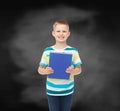 Smiling little student boy with blue book Royalty Free Stock Photo