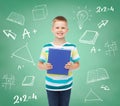 Smiling little student boy with blue book Royalty Free Stock Photo