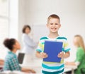 Smiling little student boy with blue book Royalty Free Stock Photo