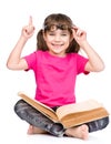 Smiling little student girl in eyeglasses with book and finger up. isolayed on white
