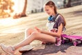 Smiling long-haired teenage girl being entertained with social media Royalty Free Stock Photo