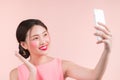 Smiling lovely active asian girl taking selfie photo Royalty Free Stock Photo