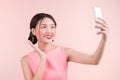 Smiling lovely active asian girl taking selfie photo. Royalty Free Stock Photo