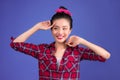 Smiling lovely asian woman dressed in pin-up style dress over bl Royalty Free Stock Photo