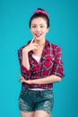 Smiling lovely asian woman dressed in pin-up style dress over bl Royalty Free Stock Photo