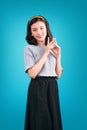 Smiling lovely asian woman dressed in pin-up style dress over bl Royalty Free Stock Photo