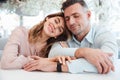 Smiling lovely couple sitting togther with closed eyes