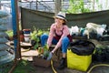 Smiling lovely young woman florist arranging plants in flower shop. The hobby has grown into a small business. Royalty Free Stock Photo