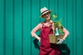 Smiling lovely young woman florist arranging plants in flower shop. The hobby has grown into a small business. Royalty Free Stock Photo