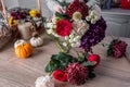 Smiling lovely young woman florist arranging plants in flower shop Royalty Free Stock Photo