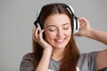 Smiling lovely young woman listening to music using headphones Royalty Free Stock Photo