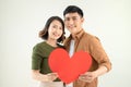 Smiling loving couple holding heart shape over white background Royalty Free Stock Photo