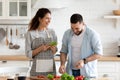 Smiling loving family couple enjoying cooking healthy food. Royalty Free Stock Photo