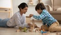 Smiling loving Indian mother and little son playing with toys Royalty Free Stock Photo
