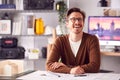 Smiling Male Architect In Office Working At Desk With Wooden Model Of Building Royalty Free Stock Photo