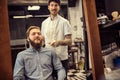 Smiling male barber giving client haircut Royalty Free Stock Photo