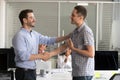 Male CEO handshake colleague greeting with job promotion