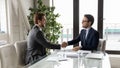 Smiling male business partners handshake at office meeting Royalty Free Stock Photo
