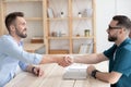 Male employer handshake job applicant greeting with employment Royalty Free Stock Photo