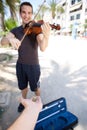 Smiling male busker playing violin Royalty Free Stock Photo