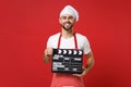 Smiling male chef cook or baker man in striped apron white t-shirt toque chefs hat isolated on red background. Cooking Royalty Free Stock Photo