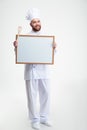 Smiling male chef cook holding blank Royalty Free Stock Photo