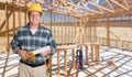 Smiling Male Contractor With House Plans Wearing Hard Hat Inside New Hou Royalty Free Stock Photo